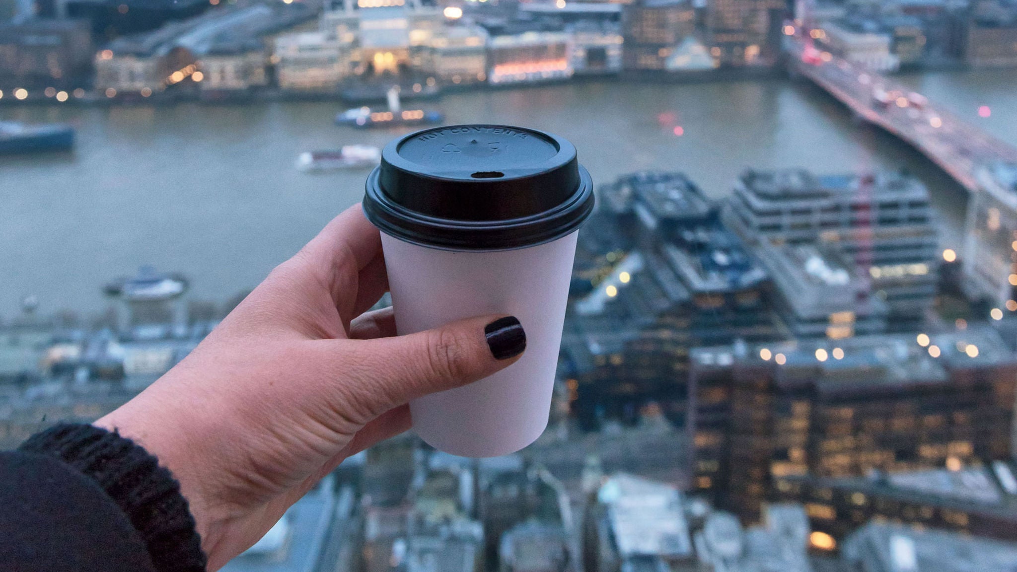 photo-woman-holding-coffee-in-front-of-london-skyline.jpg